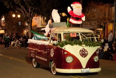 Santa atop a VW bus decked out in greenery for the Seal Beach Christmas parade.