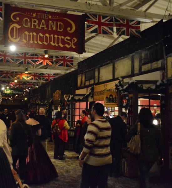 People stroll the Grand Concourse of the Dickens Christmas Fair
