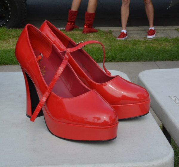 tall red strap shoes on a stand