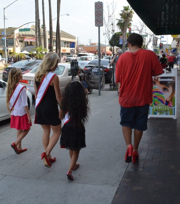 Walkers in red shoes go down Second Street