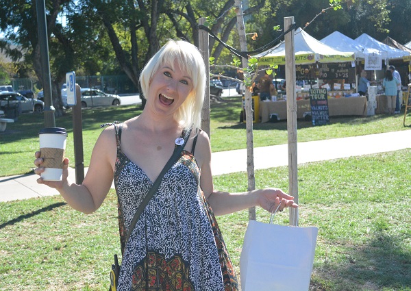 Jackalope Arts co-founder Sara Diedrich smiles as she exhibits a full shopping bag at Jackalope Fair 2015.