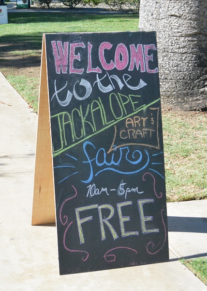 Blackboard sign welcomes visitors to Jackalope Art Fair in colored chalk
