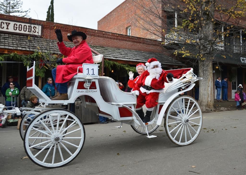 Santa and Mrs. Claus in a white wagon pulled by a horse on Columbia's Main Street