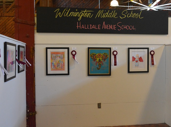 Student art work with ribbons hangs on the wall in CRAFTED art market, San Pedro.