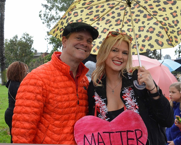 Justin Rudd with woman with "Heart Matter" sign