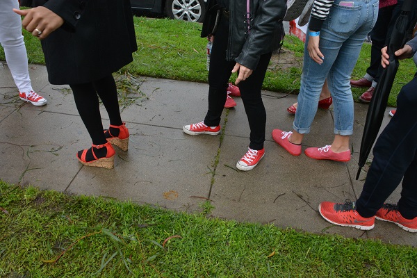 red shoe wearers on wet pavement