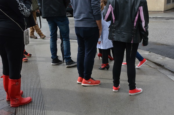 red shoes waiting at a street corner