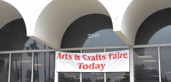 "Arts and Crafts Faire Today" sign under a white arch