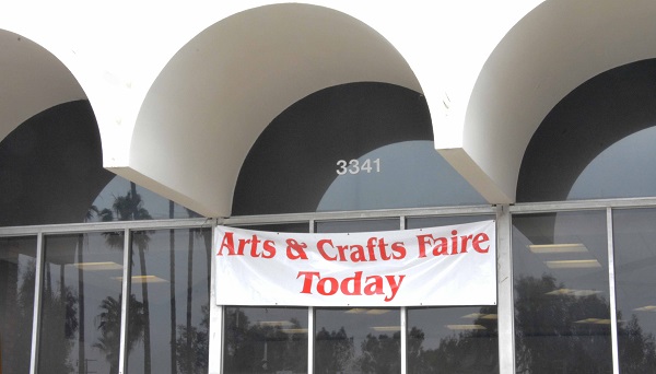 "Arts and Crafts Faire Today" sign under a white arch