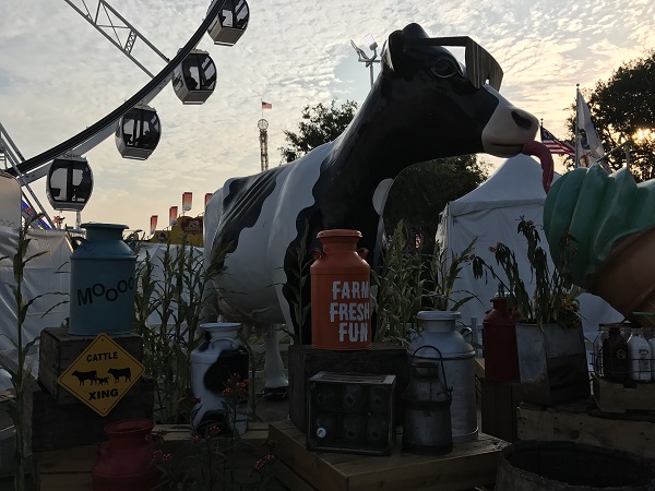 cow with "farm fresh fun" sign