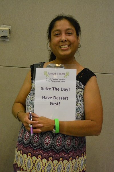 Tamiza Teja with "Eat Dessert First" sign