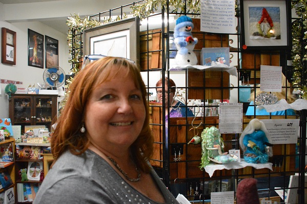 Barb Lieberman smiles near her display of needlefelted ornaments