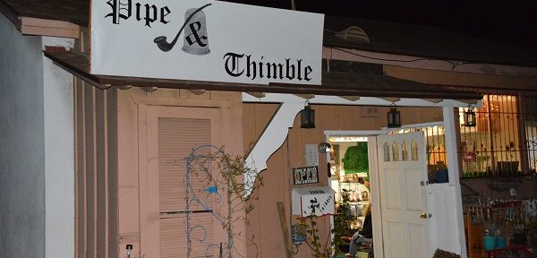 Pipe & Thimble Bookstore glows with lights at night