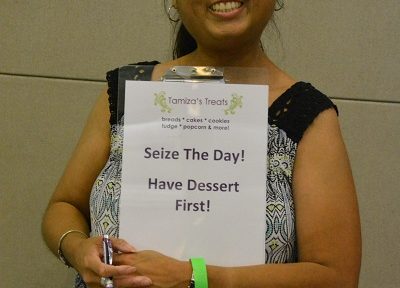 Tamiza Teja with "Life is short, eat dessert first" sign