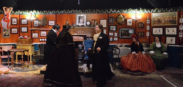 Men and women in Victorian costumes in the Adventurers Club