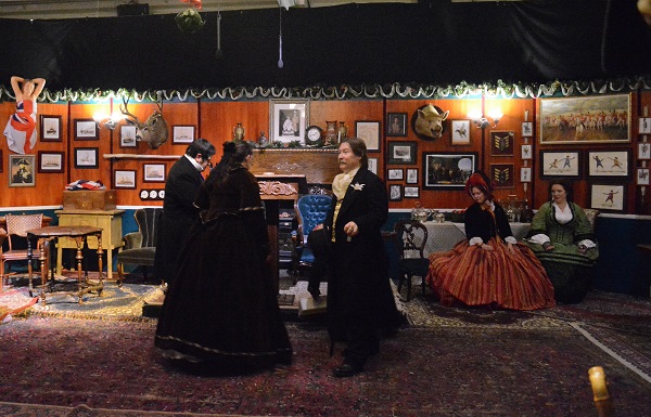 Men and women in Victorian costumes in the Adventurers Club