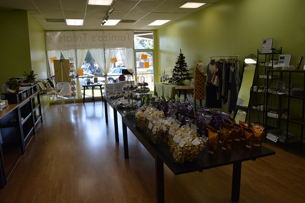 Long shot of Tamiza's Treats store with table of cookies and Christmas tree