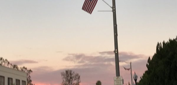 wintry sunset with flag over street