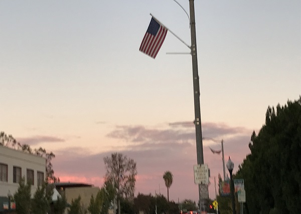 wintry sunset with flag over street
