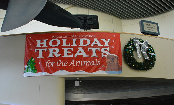 Holiday Treats sign over a doorway with Christmas wreath