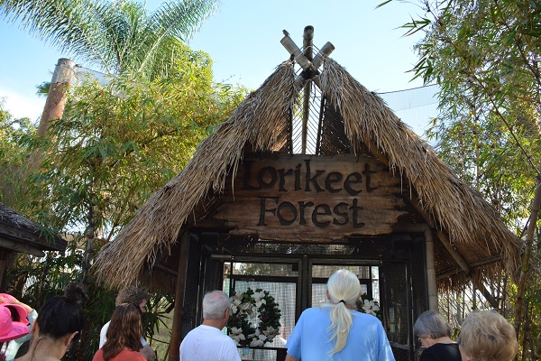 Visitors enter "Lorikeet Forest" hut facade to compound