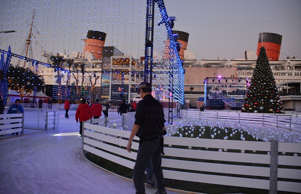 ice skaters on track at CHILL with Queen Mary in background
