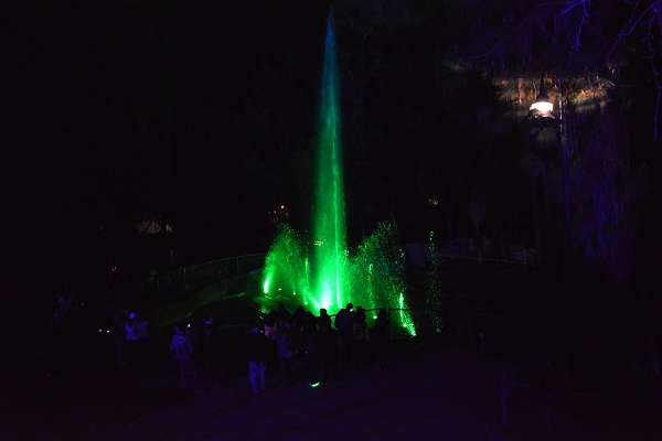 Green "Fountain" of light with audience watching