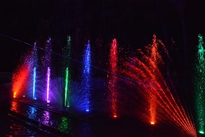 rainbow colors of water with red water jet crossing them