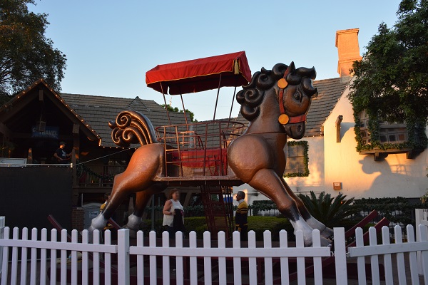 Ten-foot-tall rocking horse sits behind a picket fence