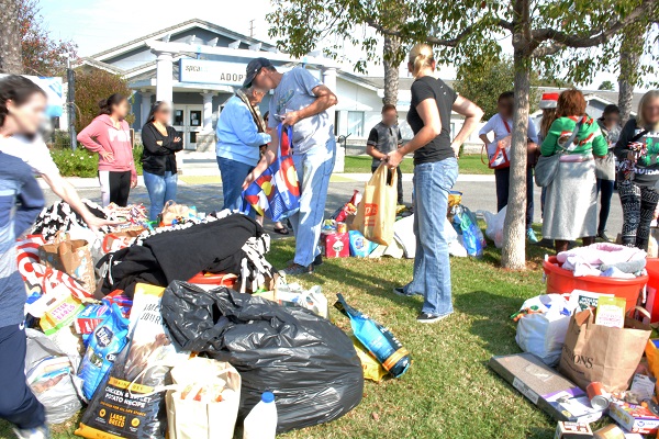 Volunteers set out pet food and supplies outside Long Beach Animal Care Services building