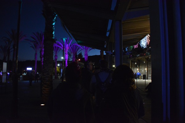 people wait in line outside Los Angeles Zoo gates at night