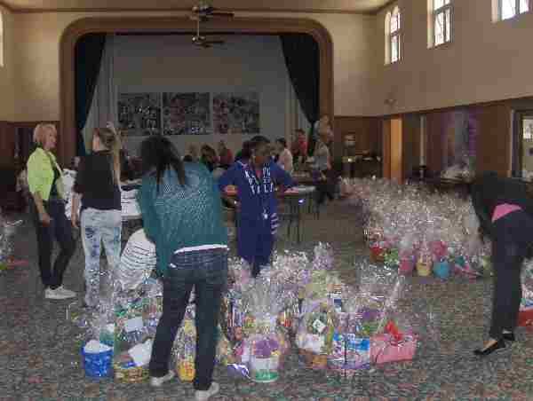 Volunteers assemble Easter baskets in main church hall