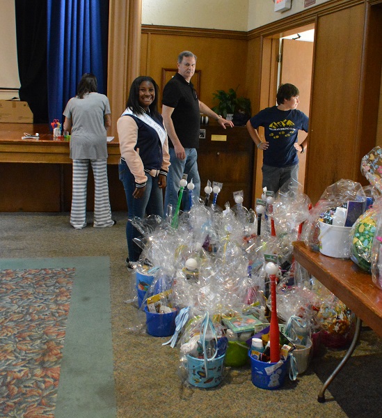 Volunteers prepare to carry the last few Easter baskets out the door