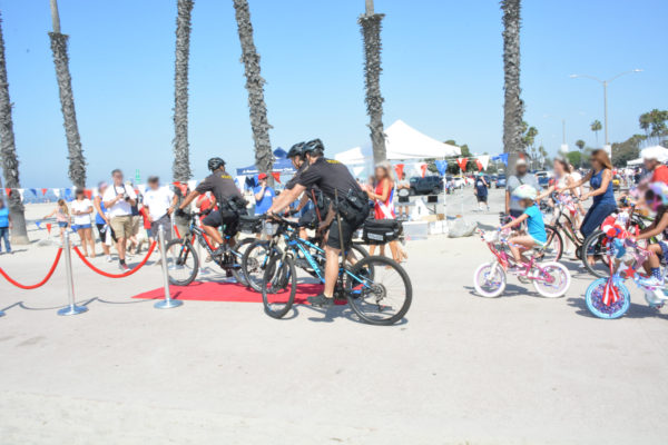 Police officers lead off the 2017 Fourth of July Kids Bike Parade at the beach