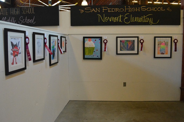 Student art exhibit on the wall of CRAFTED under blackboard with "San Pedro High School, Normont Elementary" in chalk