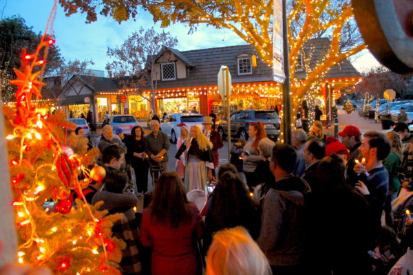 Candlelight Tpur attendees on main street decorated for Christmas near sunset