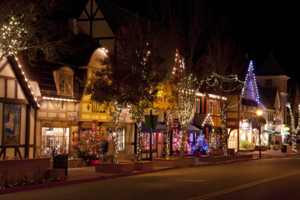 Downtown Solvang street at night, decorated for Christmas with greenery and lights