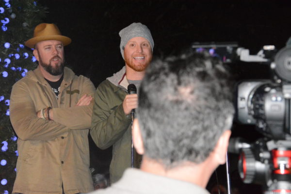 Justin Turner of Los Angeles Dodgers addresses L.A. Zoo Lights attendees as actor Chris Sullivan looks on