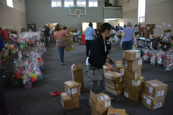 Volunteers in the midst of supplies and boxes