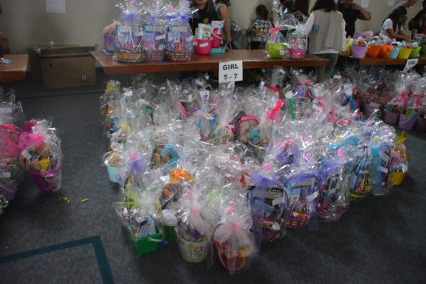 Wrapped Easter baskets in group with sign, "Girl, 5-7".