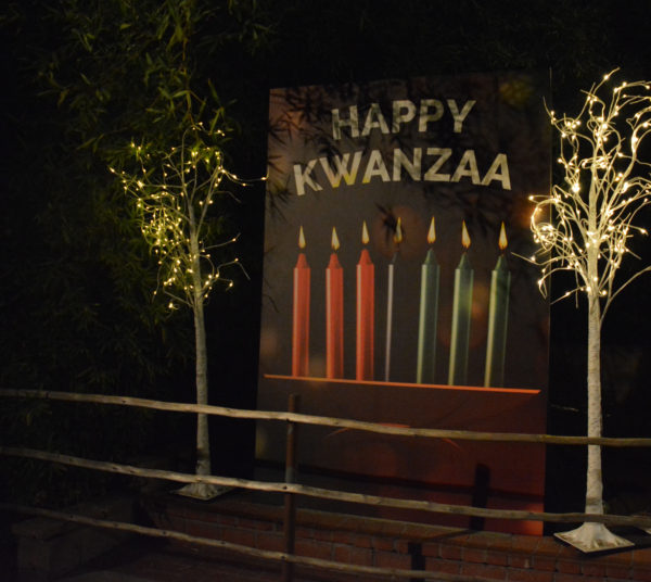 "Happy Kwanzaa" banner with seven candles in a kinara