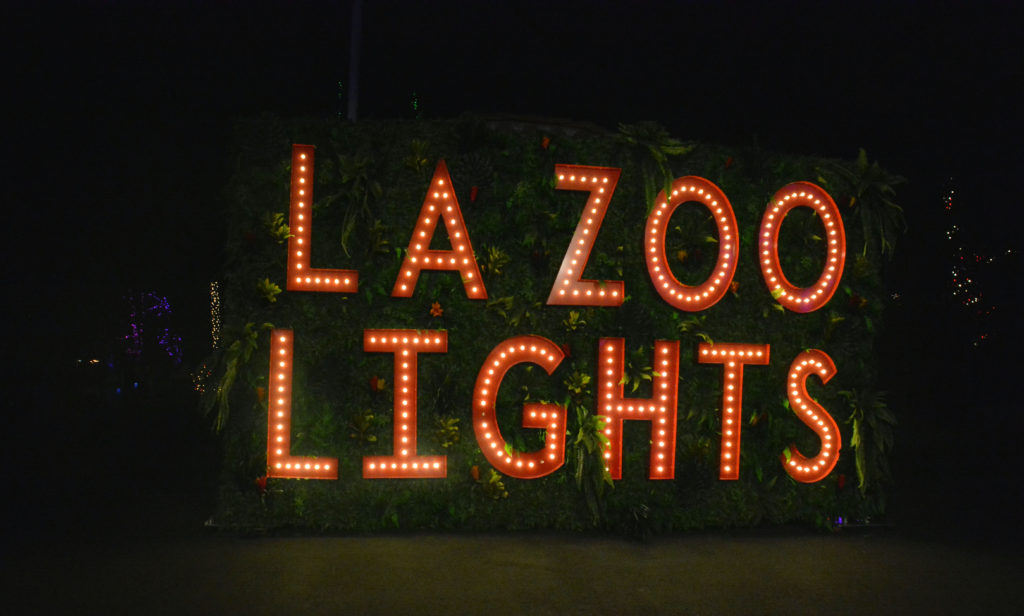 L.A. Zoo Lights in red tin sign with gold lights