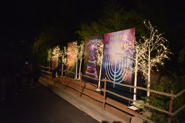 Four banners with "Happy Hanukkah", "Feliz Navidad", "Merry Christmas", and "Happy Kwanzaa" in a display