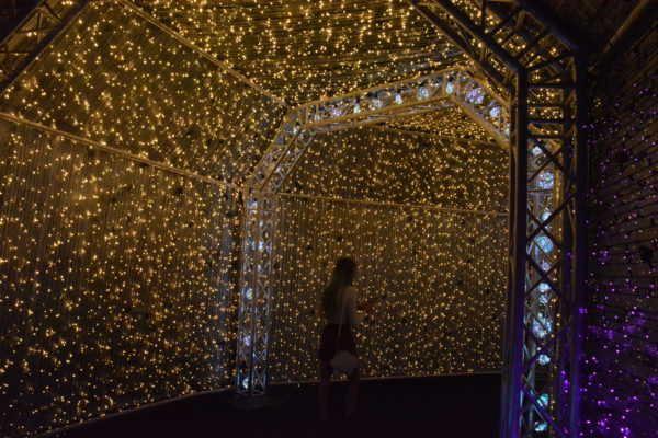 Girl in silhouette as she walks though gold lights and crystal archway in "Twinkle Tunnel"