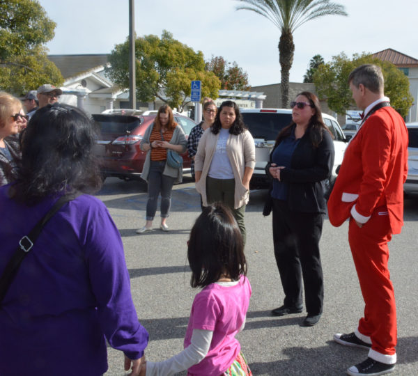 Christine Kucenas speaks to Justin Rudd and several gathered volunteers in Long Beach ACS parking lot