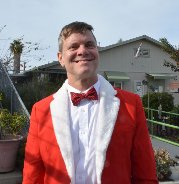Community activist Justin Rudd, in red Santa suit, smiles outside Seal Beach Animal Care during Operation Santa Paws 2019