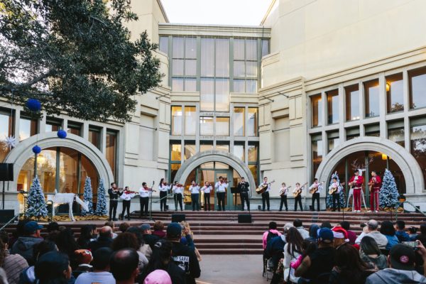 Visitors listen as performers play their instruments on the front steps of California Center for the Arts