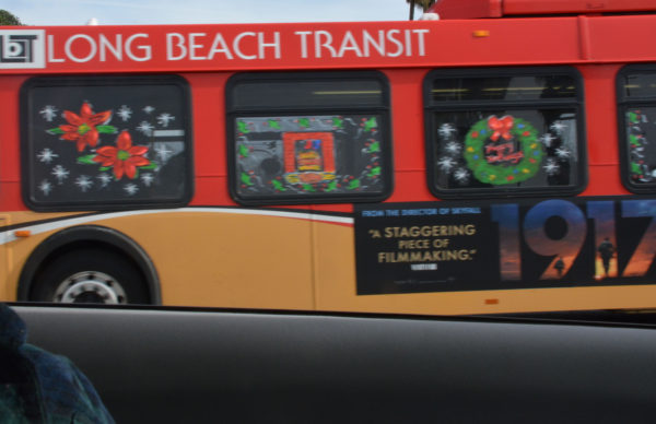 Long Beach Transit bus with windows painted with poinsettias and Christmas wreaths