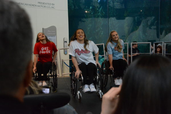 Chelsie and two other Rollettes smile as they rock their chairs during dance routine