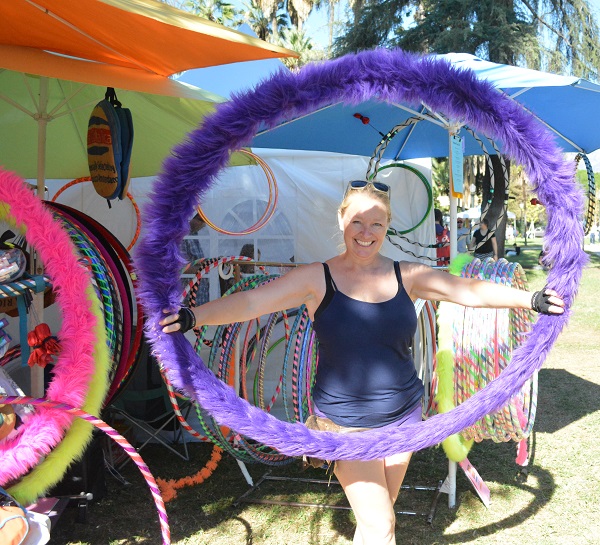 Jen Jensen poses in a fur-covered purple hula hoop at Jackalope Art and Craft Fair, in Pasadena's Central Park.